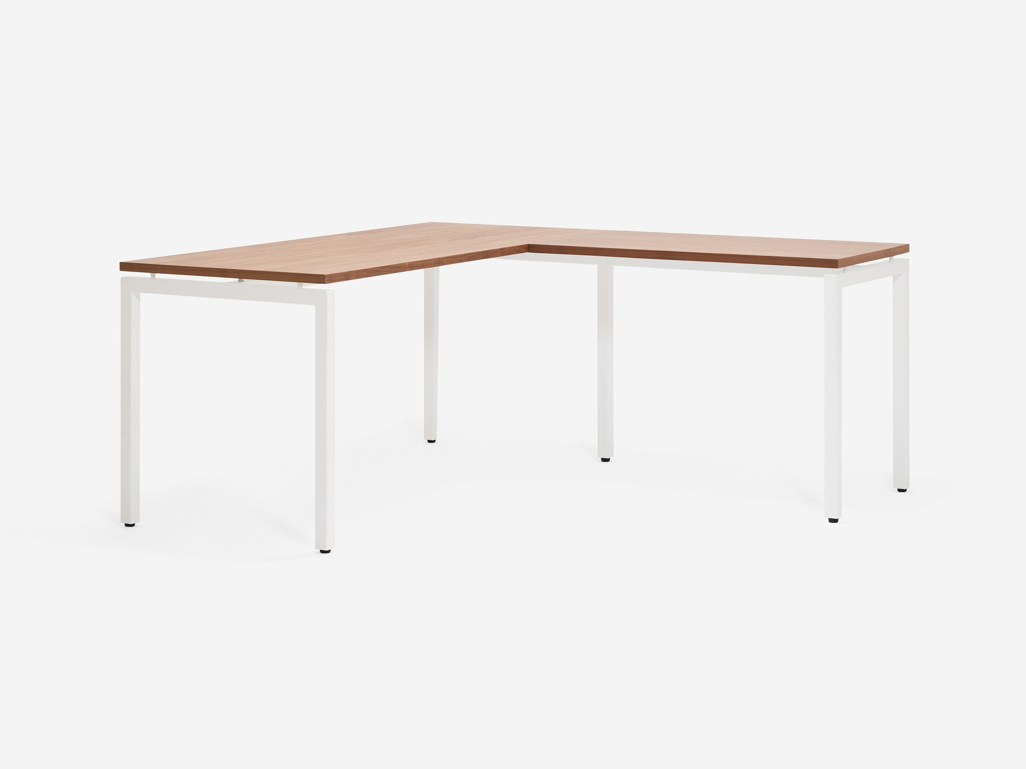 Angled view of the Novah custom left hand l shaped desk with walnut top and white base